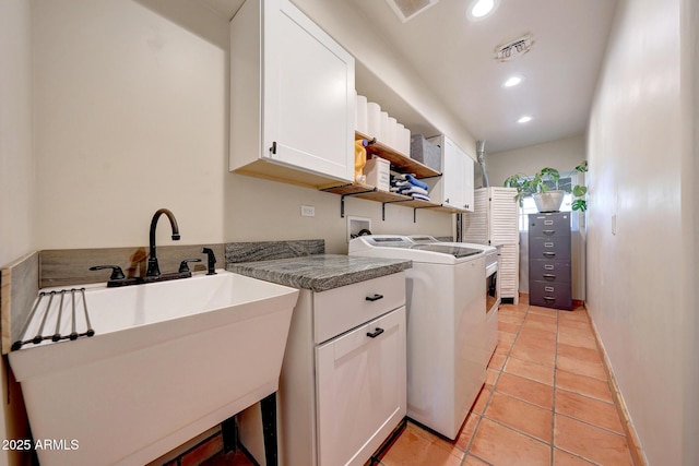 laundry room featuring cabinet space, separate washer and dryer, recessed lighting, baseboards, and light tile patterned floors