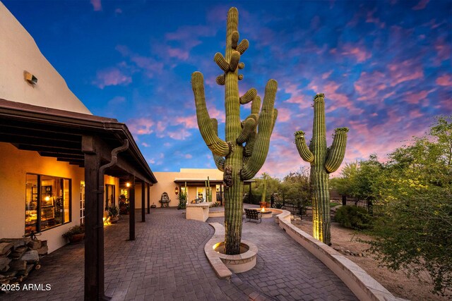 patio terrace at dusk with a fire pit