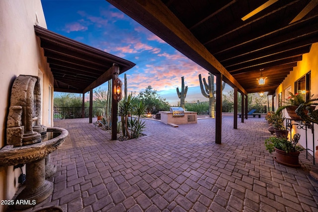 patio terrace at dusk with an outdoor kitchen