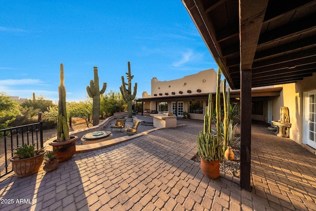 view of patio with a fire pit and area for grilling