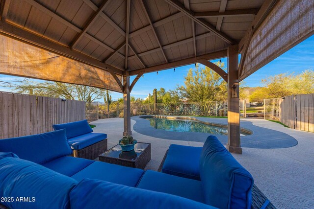view of patio with outdoor lounge area, a fenced backyard, and a hot tub