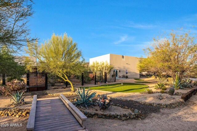 view of property's community featuring an area to practice putting