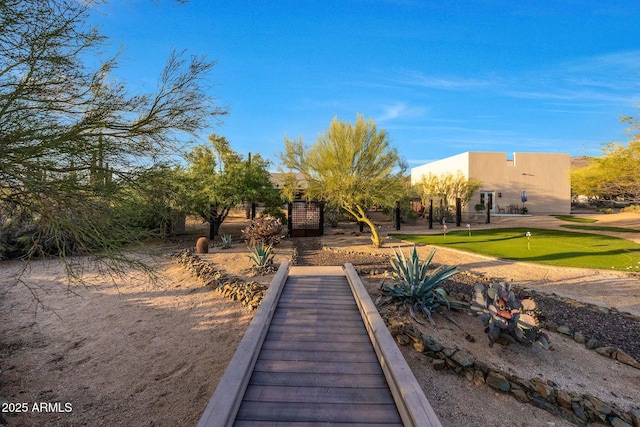view of home's community featuring a putting green
