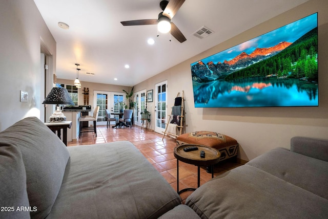 living area featuring tile patterned floors, recessed lighting, a ceiling fan, and french doors