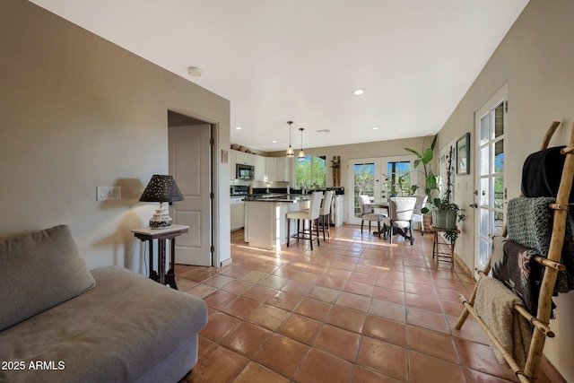 living room featuring light tile patterned floors, french doors, and recessed lighting