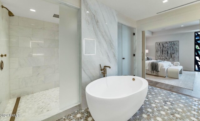 bathroom with tile flooring and separate shower and tub