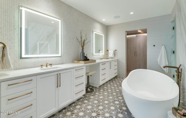 bathroom featuring tile flooring, vanity, and a washtub