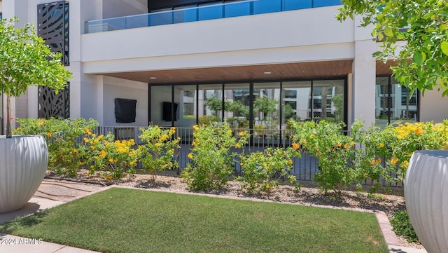 exterior space with a lawn and a balcony