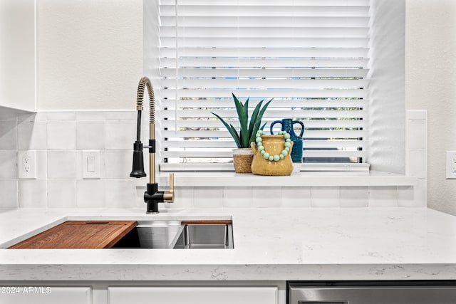 room details featuring sink and tasteful backsplash