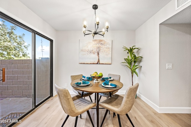 dining area featuring an inviting chandelier and light wood-type flooring