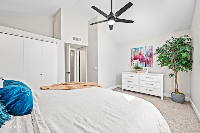 carpeted bedroom with high vaulted ceiling, ceiling fan, and a closet