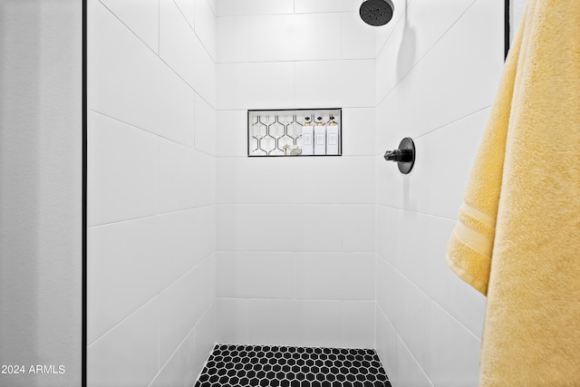 bathroom with tiled shower