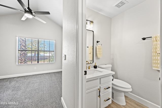 bathroom featuring vanity, wood-type flooring, lofted ceiling, ceiling fan, and toilet