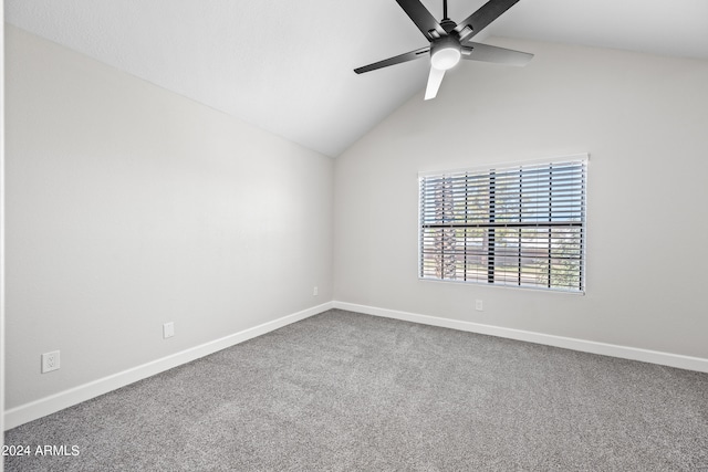 carpeted empty room featuring ceiling fan and vaulted ceiling