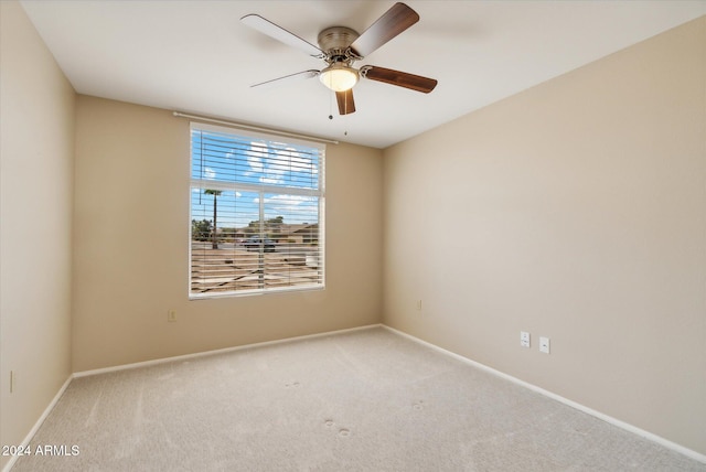 unfurnished room featuring light carpet and ceiling fan