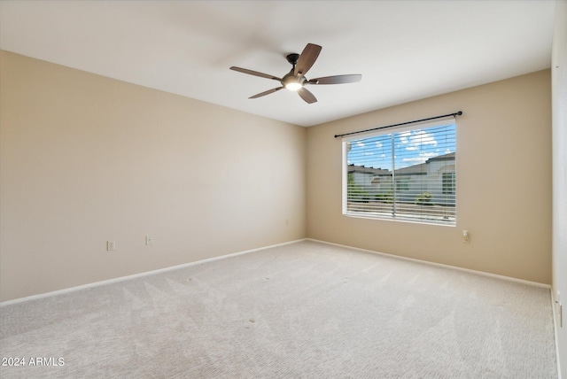 empty room featuring ceiling fan and light colored carpet