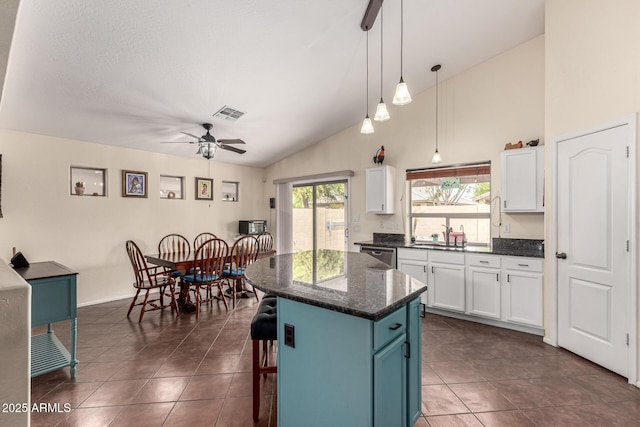 kitchen featuring dishwasher, a ceiling fan, white cabinetry, and visible vents