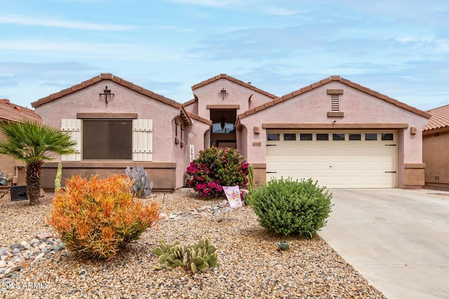 view of front facade featuring concrete driveway, stucco siding, and an attached garage