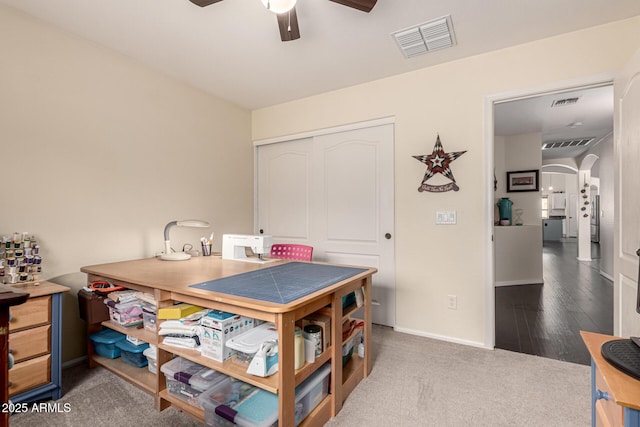 office area featuring baseboards, visible vents, arched walkways, and a ceiling fan