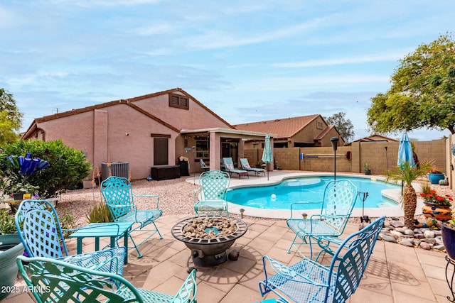 view of pool featuring an outdoor fire pit, a fenced backyard, a fenced in pool, and a patio area