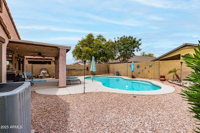 view of swimming pool with ceiling fan, a fenced backyard, a fenced in pool, cooling unit, and a patio area