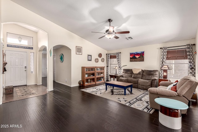 living room featuring arched walkways, lofted ceiling, wood finished floors, and a ceiling fan