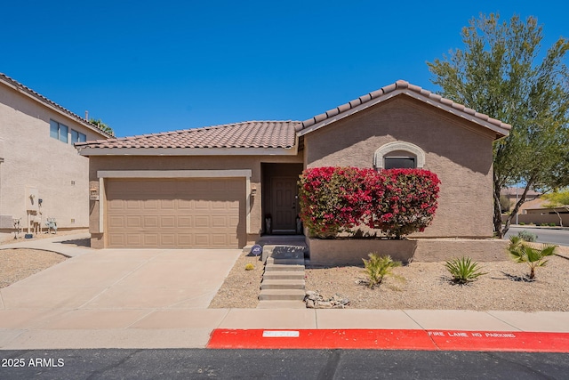 1702 W Wildwood Dr, Phoenix, AZ 85045 - view of front of home with a tiled roof, a garage, stucco siding, and concrete driveway