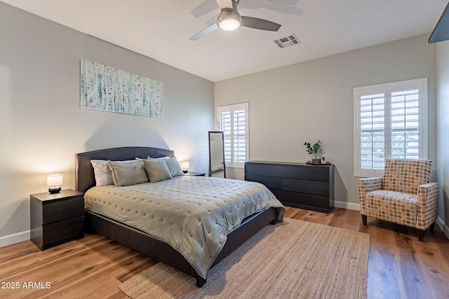 1702 W Wildwood Dr, Phoenix, AZ 85045 - bedroom with light wood-type flooring, visible vents, multiple windows, and baseboards