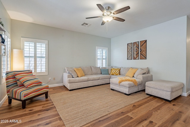 1702 W Wildwood Dr, Phoenix, AZ 85045 - living room with visible vents, ceiling fan, plenty of natural light, and wood finished floors