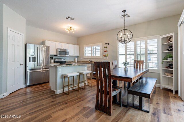 1702 W Wildwood Dr, Phoenix, AZ 85045 - dining area featuring a notable chandelier, visible vents, and dark wood finished floors