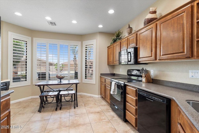 11025 E Nichols Ave, Mesa, AZ 85209 - kitchen with black appliances, recessed lighting, brown cabinetry, and baseboards