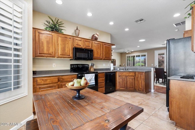 11025 E Nichols Ave, Mesa, AZ 85209 - kitchen with black appliances, a sink, brown cabinets, a peninsula, and recessed lighting