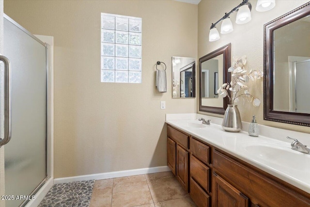 11025 E Nichols Ave, Mesa, AZ 85209 - bathroom featuring a shower with door, double vanity, and baseboards