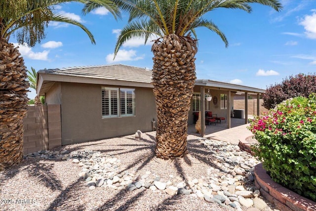 11025 E Nichols Ave, Mesa, AZ 85209 - back of house with stucco siding, a patio area, central AC unit, and a tile roof