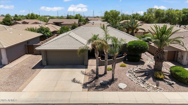 11025 E Nichols Ave, Mesa, AZ 85209 - view of front of house featuring a garage, concrete driveway, a tile roof, and stucco siding