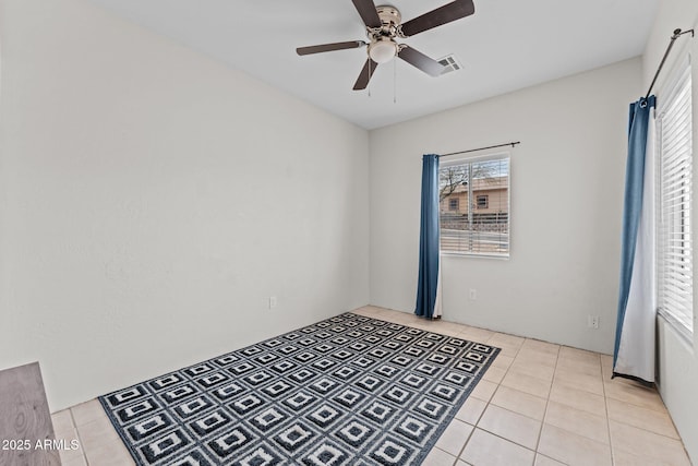 unfurnished room featuring visible vents, a ceiling fan, and light tile patterned flooring