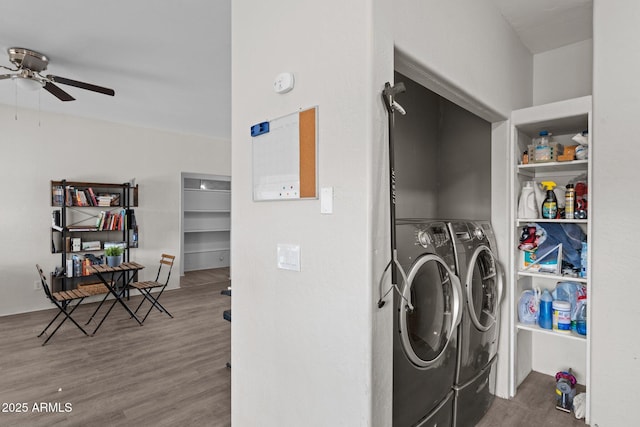 laundry room with laundry area, washer and clothes dryer, wood finished floors, and a ceiling fan