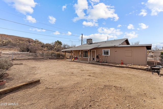 rear view of house featuring a fenced backyard and a patio