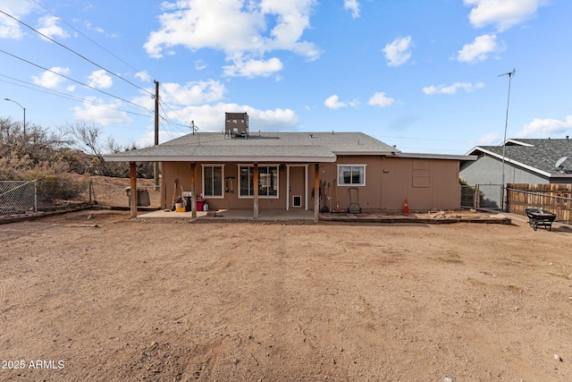 rear view of property with a patio, central AC unit, fence, and a gate