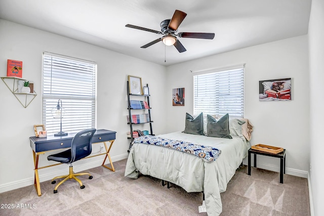 carpeted bedroom featuring baseboards and ceiling fan