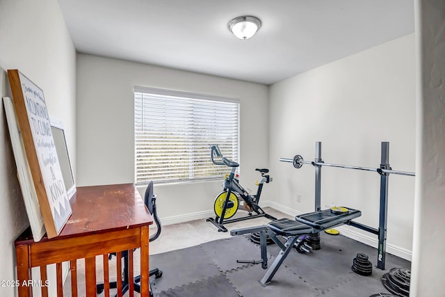 workout room featuring baseboards