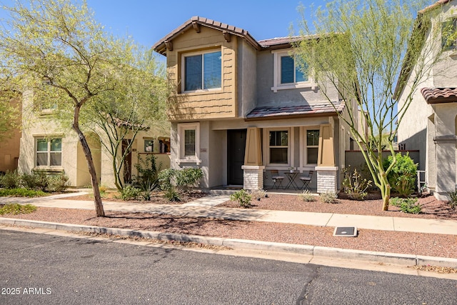 view of front of home with a tiled roof and stucco siding