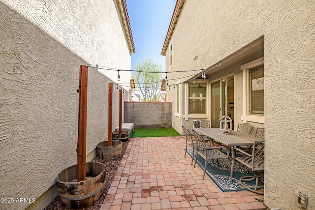 view of patio featuring outdoor dining area and fence