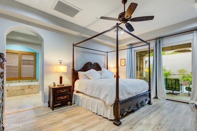 bedroom featuring light hardwood / wood-style floors, ceiling fan, ensuite bathroom, and access to exterior