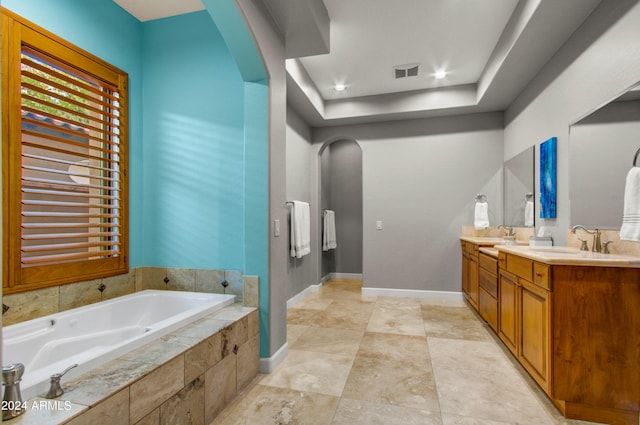 bathroom with tiled bath and vanity