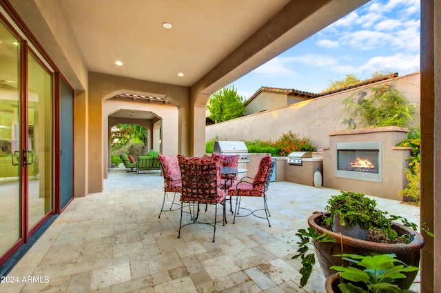 view of patio with a bar, area for grilling, and a grill