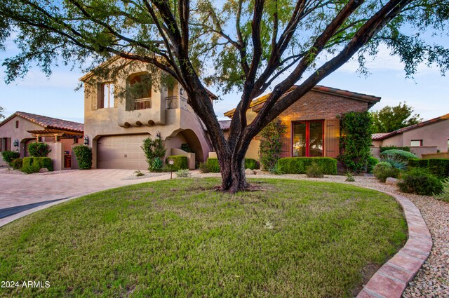 3129 S Honeysuckle Ct, Gold Canyon, AZ 85118 - mediterranean / spanish house featuring stucco siding, decorative driveway, a garage, and a front lawn