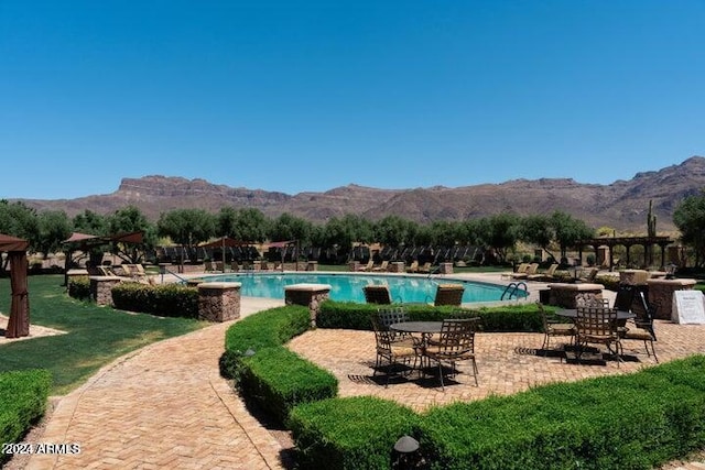 view of swimming pool featuring a mountain view and a patio area