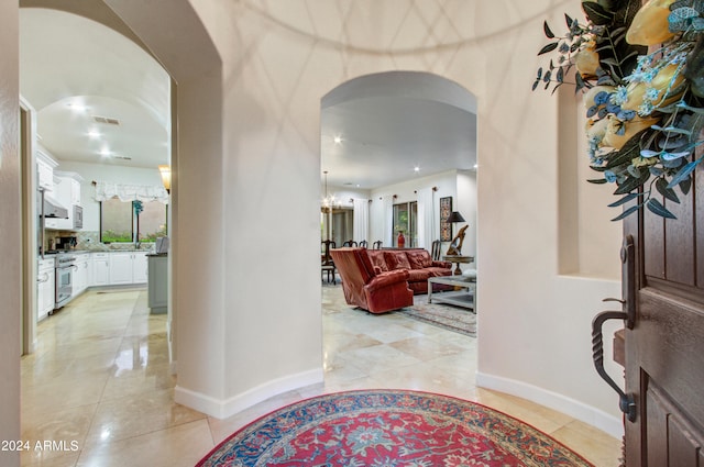 entryway with a chandelier