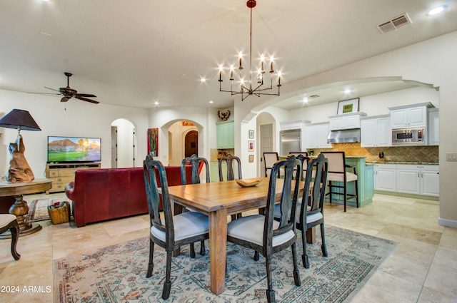 dining space featuring ceiling fan with notable chandelier and light tile patterned floors